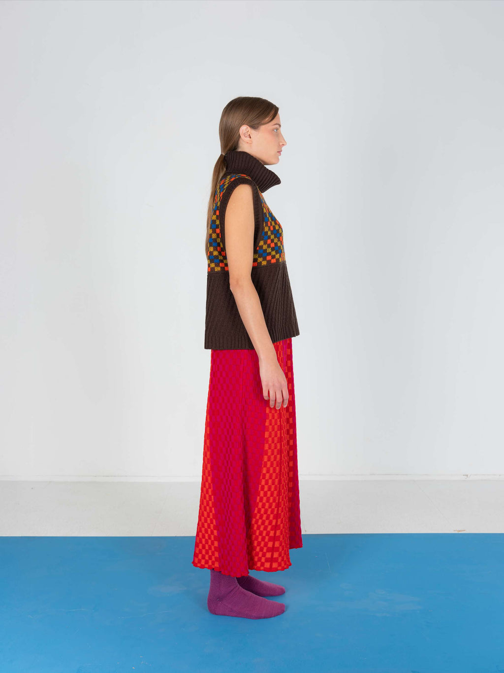 Product view of the Red Checkered Wavy Skirt, knitted skirt in a red-accented, wavy textured checkered plated pattern. By JONA BEDNJANEC.