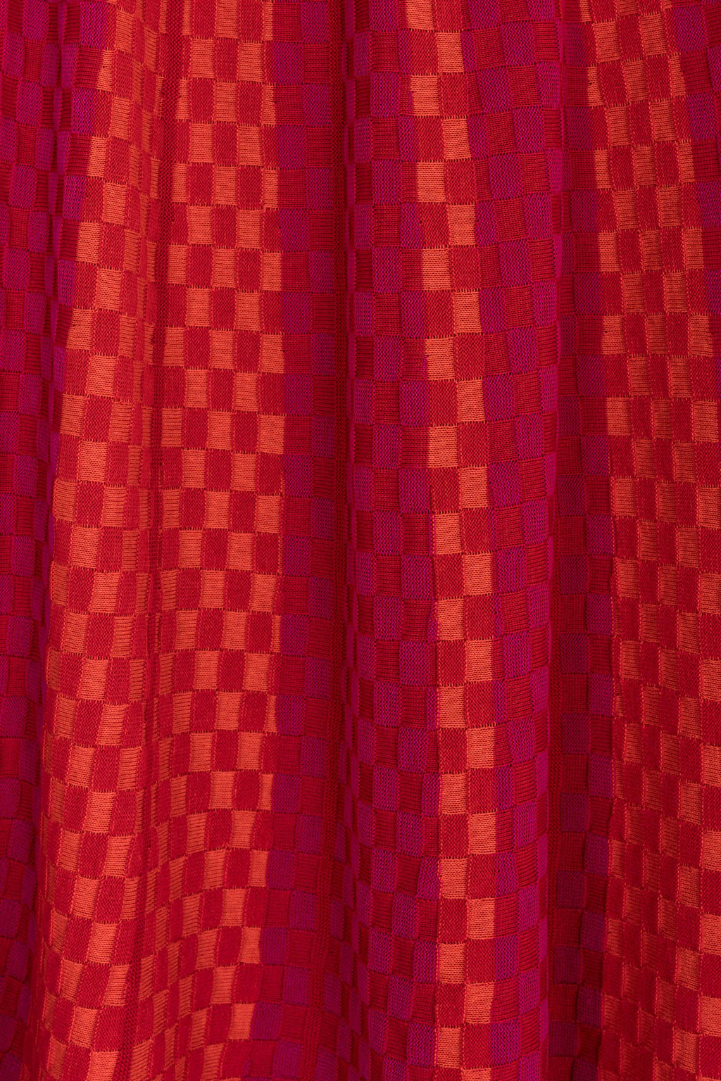 Product view of the Red Checkered Wavy Skirt, knitted skirt in a red-accented, wavy textured checkered plated pattern. By JONA BEDNJANEC.