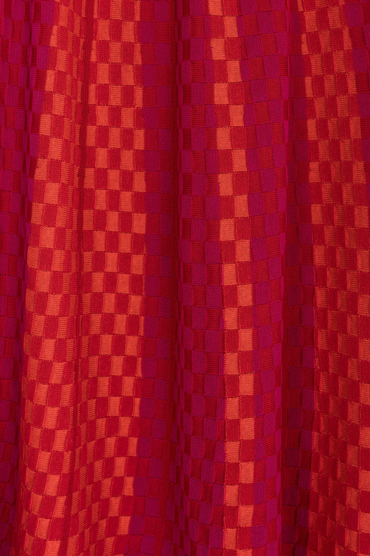 Product view of the Red Checkered Wavy Skirt, knitted skirt in a red-accented, wavy textured checkered plated pattern. By JONA BEDNJANEC.